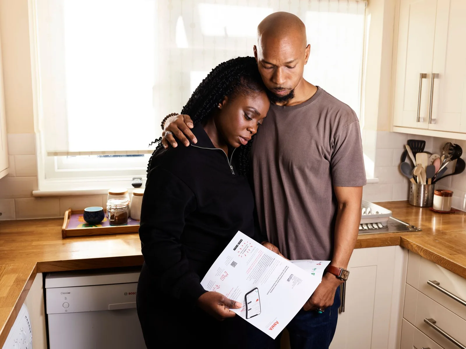 Couple examinant un courrier dans sa cuisine