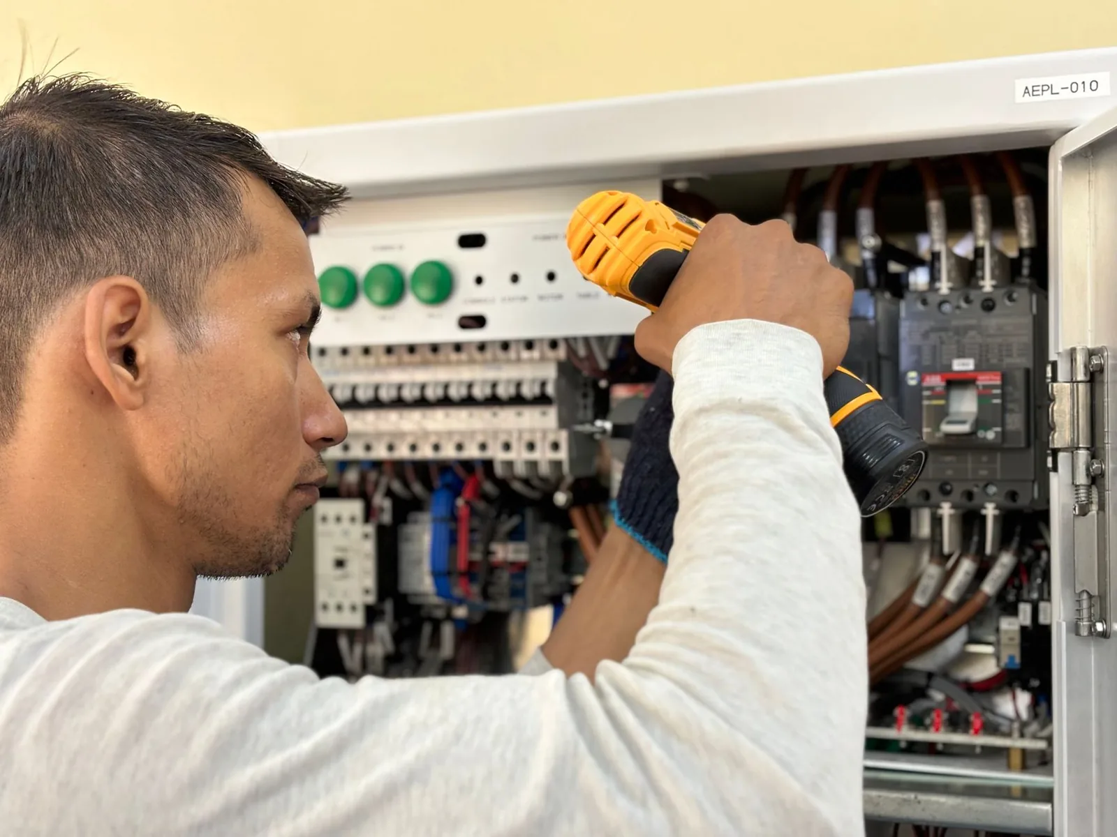 Électricien intervenant sur un tableau électrique de bâtiment